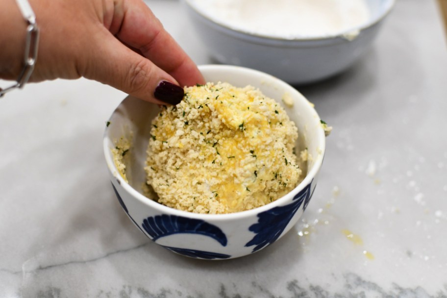 dipping boursin cheese into panko bread crumbs