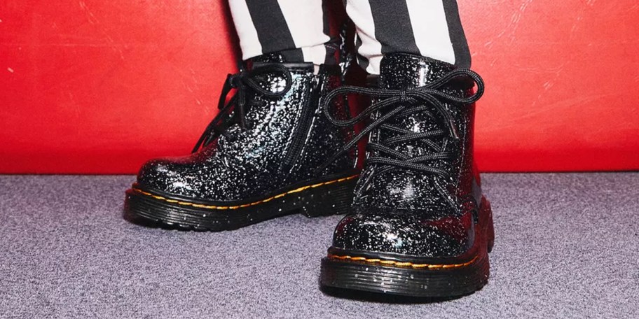 person wearing pair of glitter dr marten boots