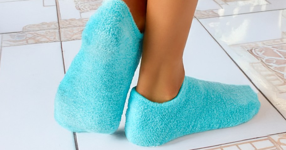 person wearing gel socks on tile floor