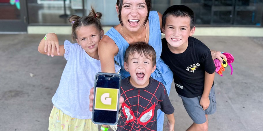 family holding phone with getout pass on display