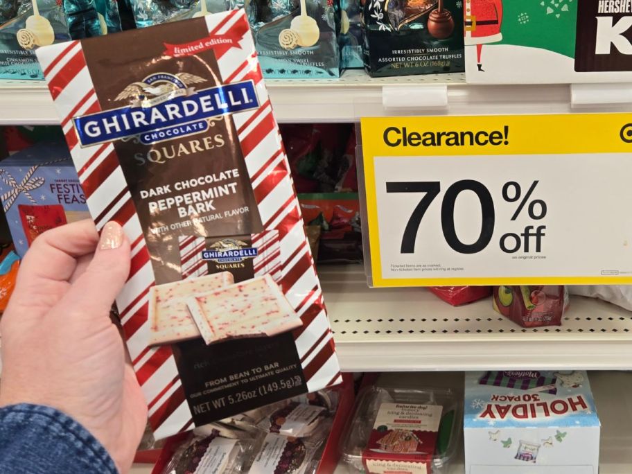 womans hand holding a bag of peppermint bark