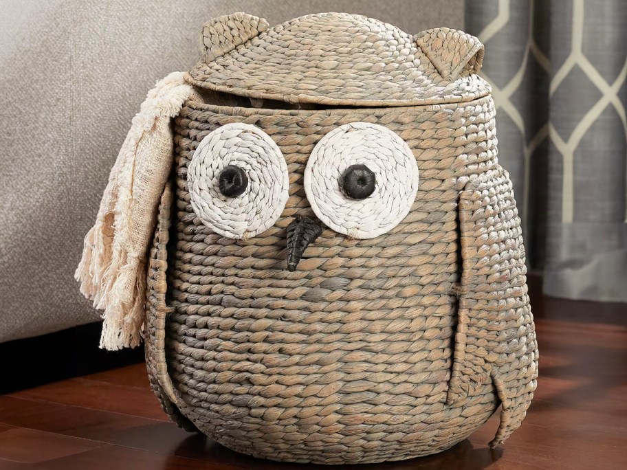 owl storage basket with blanket hanging out 