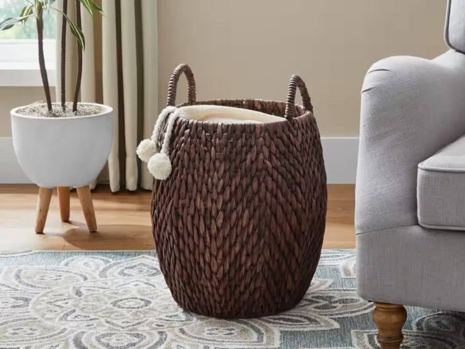 dark brown wicker storage basket with blanket inside 