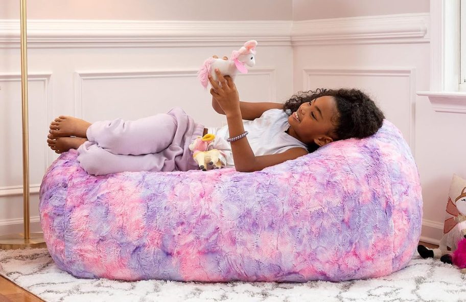 girl laying on tie dye bean bag in room