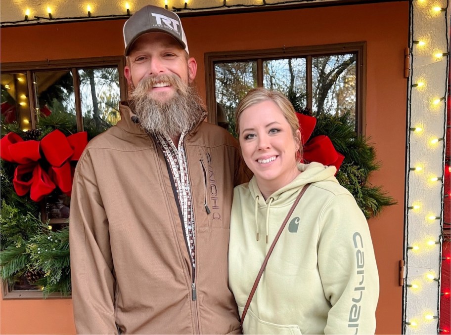 couple standing in front of christmas store