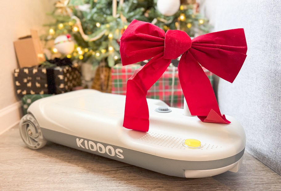 kids ride on cart under Christmas Tree