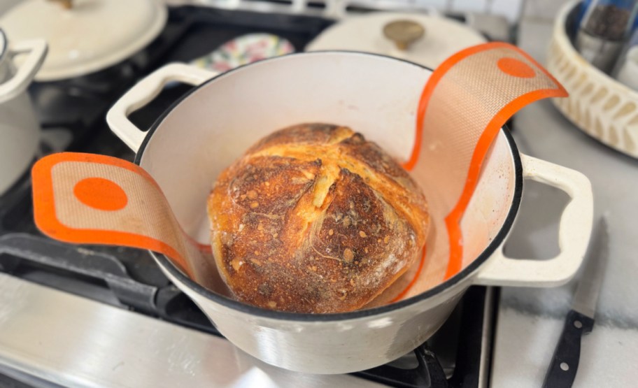 loaf of baked sourdough in a dutch oven