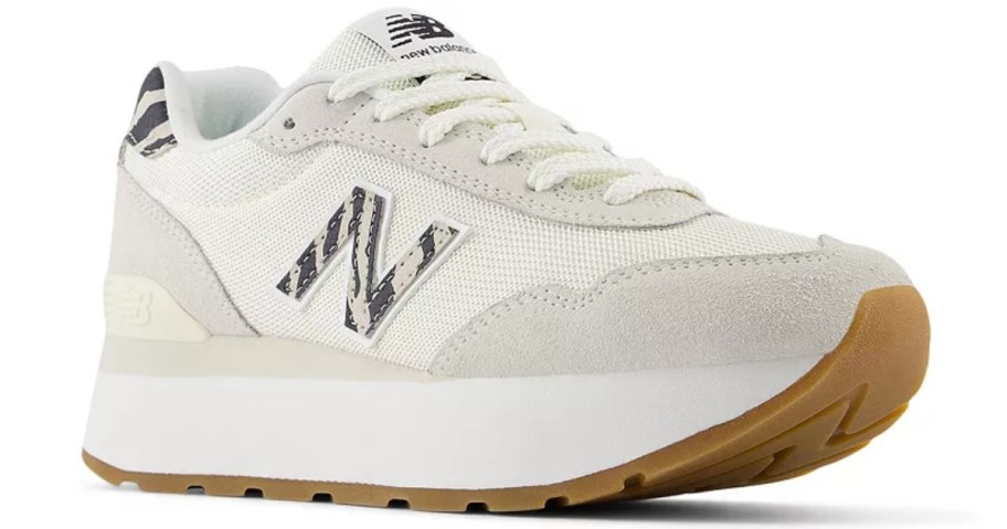 a women's New Balance sneaker in white with light grey and black and white accents