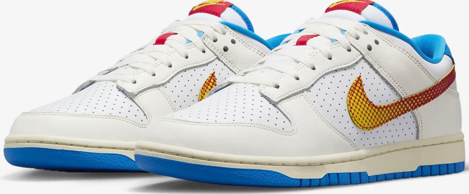 a pair of white, blue, and yellow Nike Dunk shoes