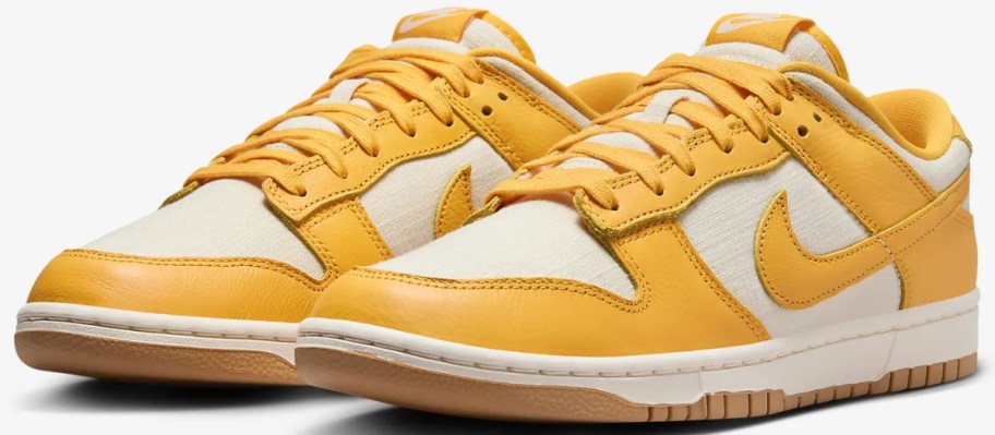 a pair of men's Nike Dunk low top shoes in off white and yellow