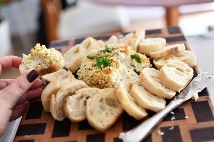 spreading boursin dip on bread