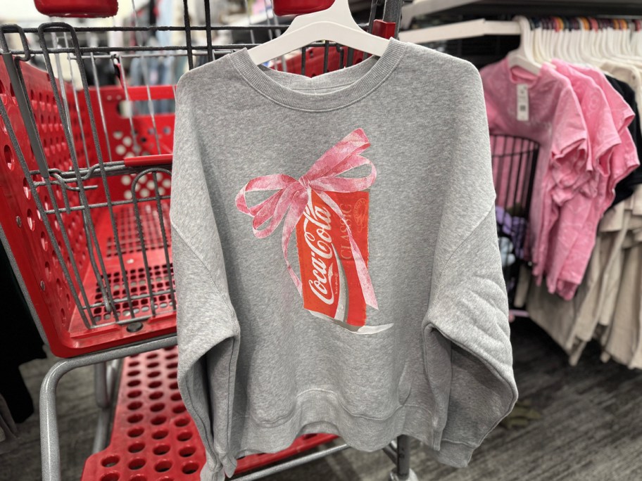 gray coca-cola sweatshirt hanging on target shopping cart 