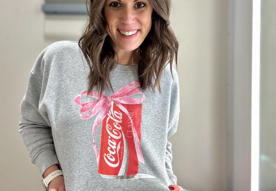 woman wearing gray coca-cola sweatshirt