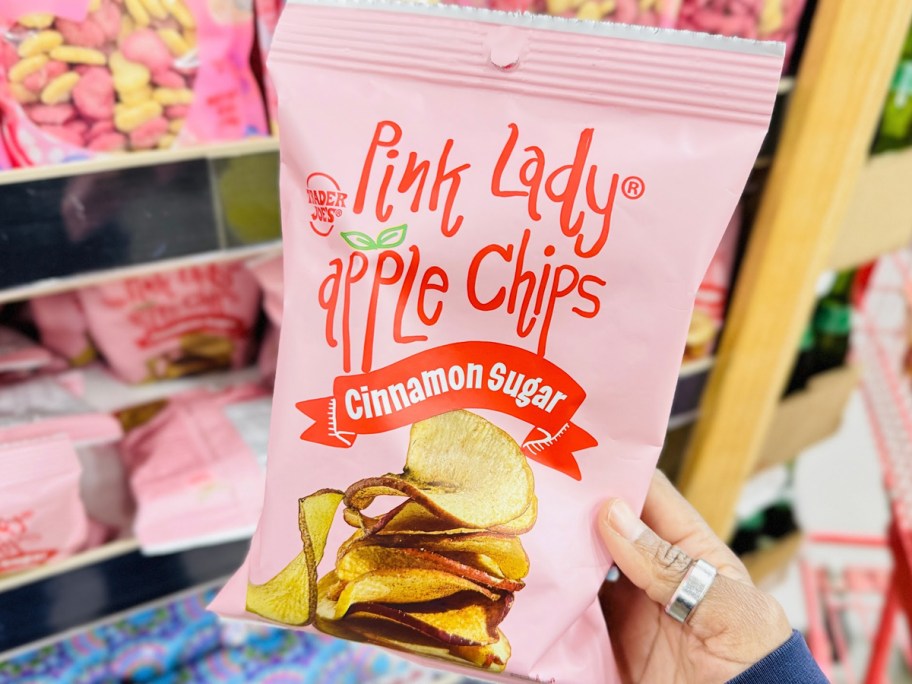 hand holding pink lady apple chips bag 