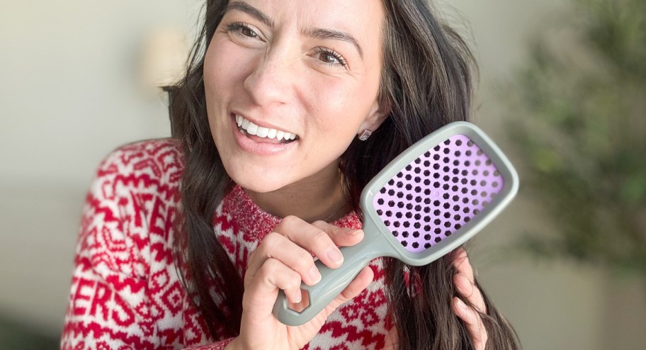 woman using unbrush on her hair