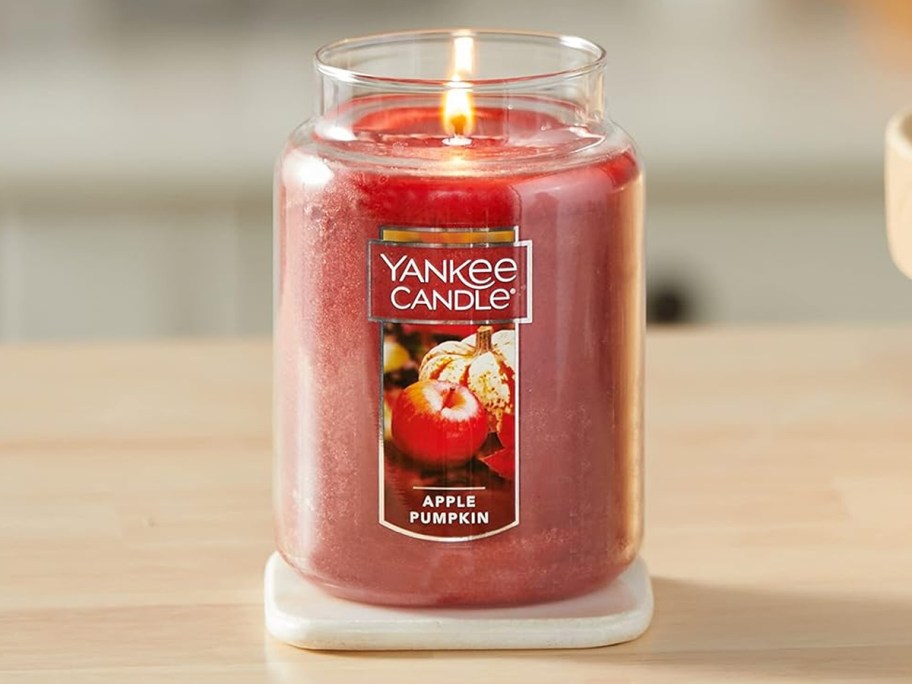 red apple pumpkin yankee candle on table