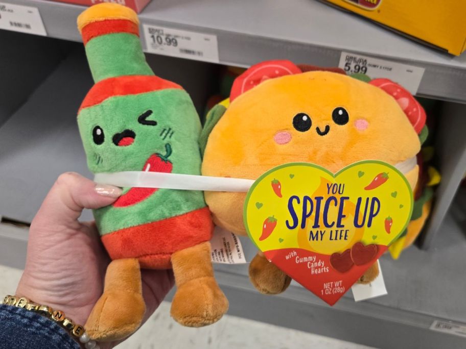 a womans hand holding a hot sauce and taco valentines plush gift