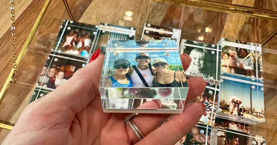 2×2 Acrylic Photo Block in hand above several others in a jewelry box