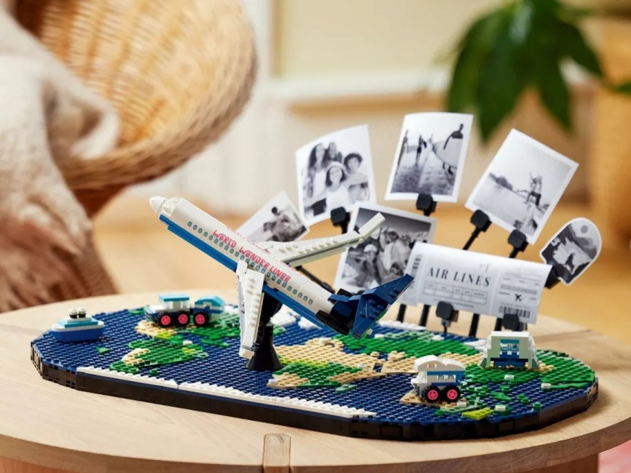 a LEGO world map set with a LEGO airplane and photos