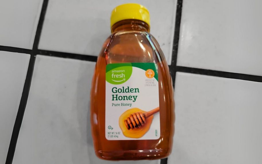 a bottle of amazon fresh honey on a kitchen counter