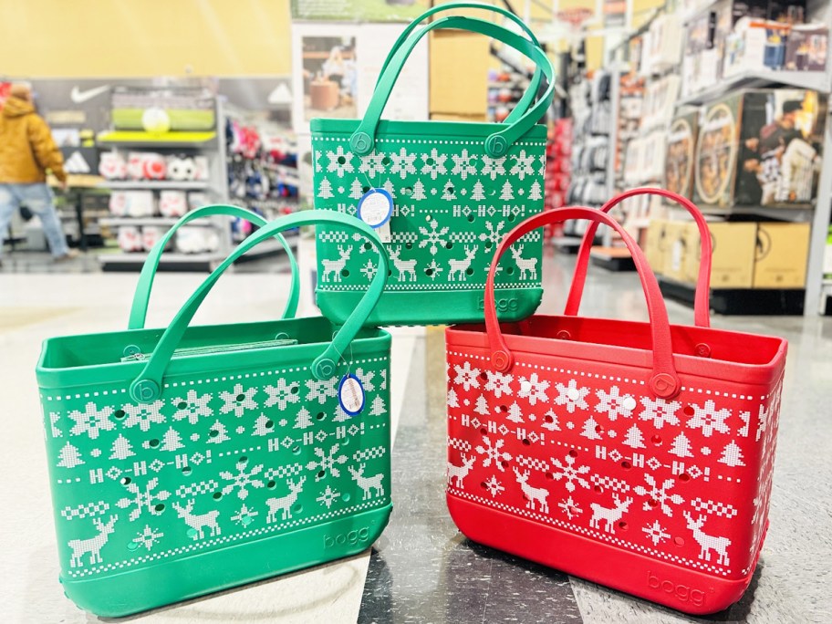 stack of green and red ugly sweater print bogg bags