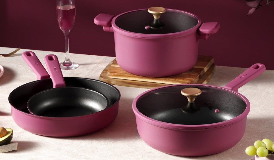 carote cookware pots and pans in pink on kitchen counter