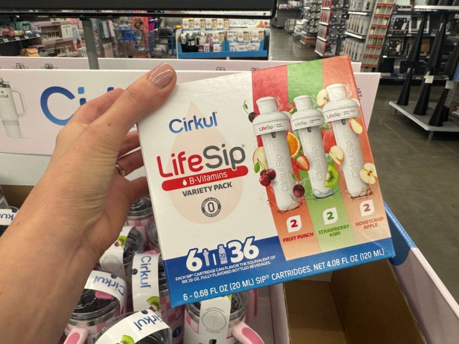 a person holding Cirkul cartridges 