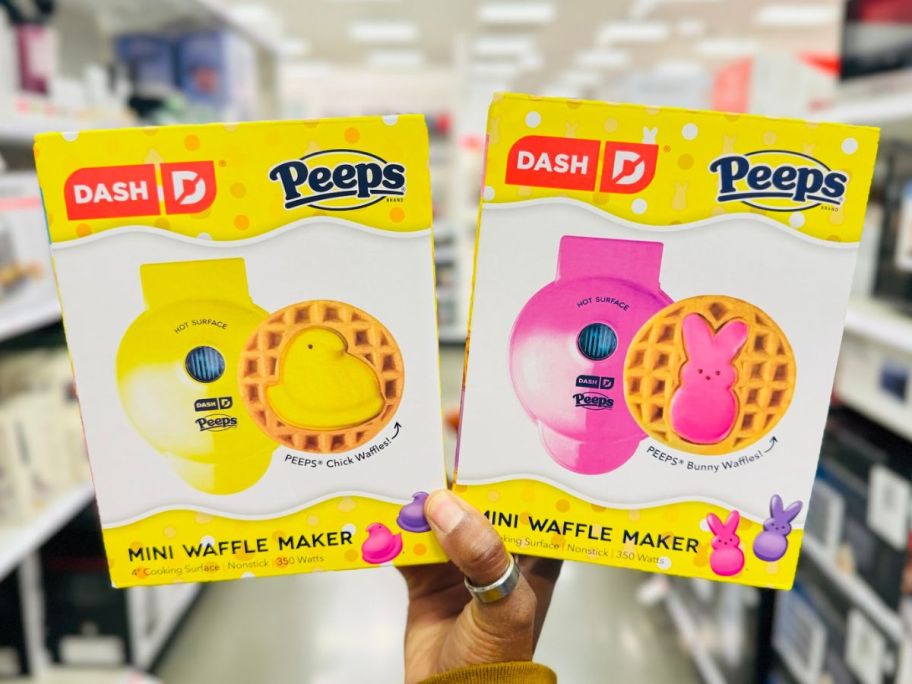 Hand holding two Dash Peeps Mini Waffle Maker