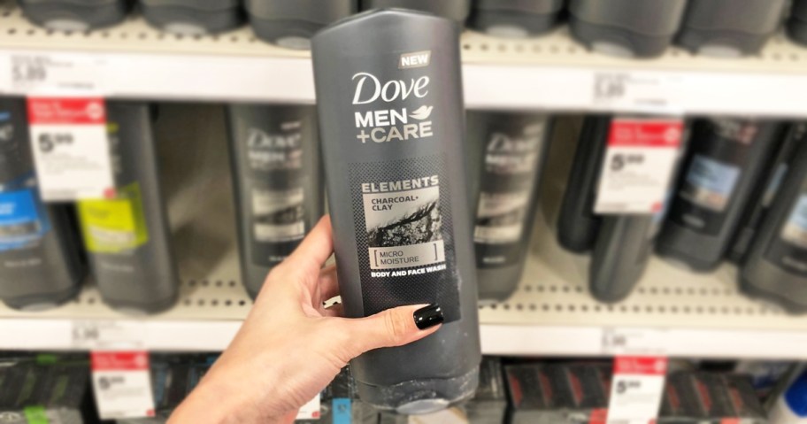 hand holding up a grey bottle of Dove Men + Care Body & Face Wash in store