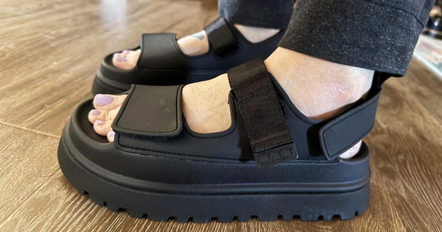 woman wearing pair of black platform sandals