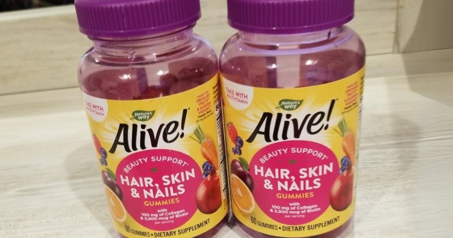 2 purple bottles of Nature's Way Alive! Hair, Skin & Nails Gummies supplements on a kitchen counter