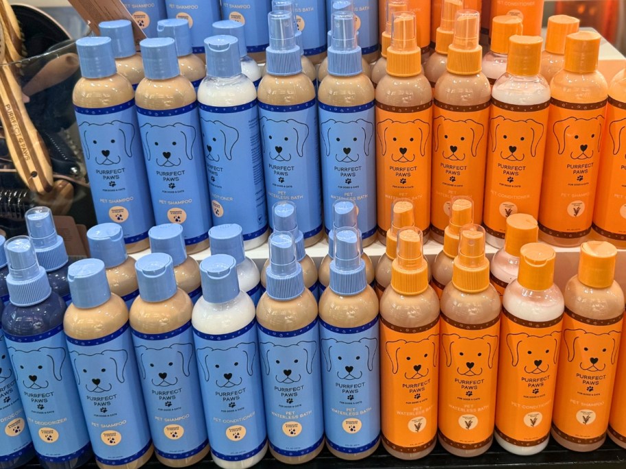 blue and orange bottles of Bath & Body Works Pet Care Items on a store display