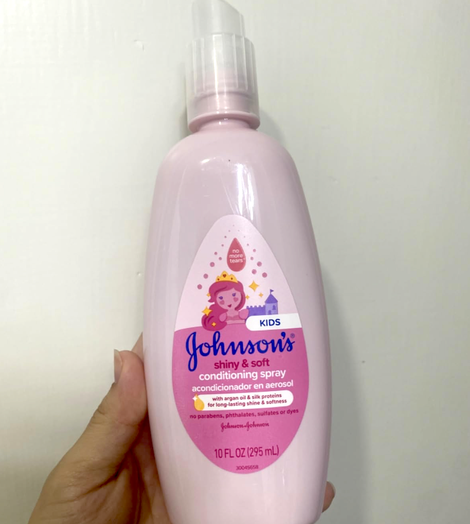 holding Johnson's conditioning spray 