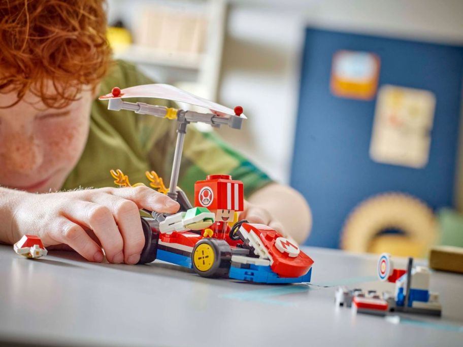 kid playing with LEGO Mario Kart Standard Kart