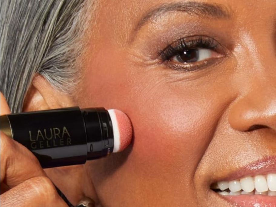 Woman using a Laura Geller Serum Blush