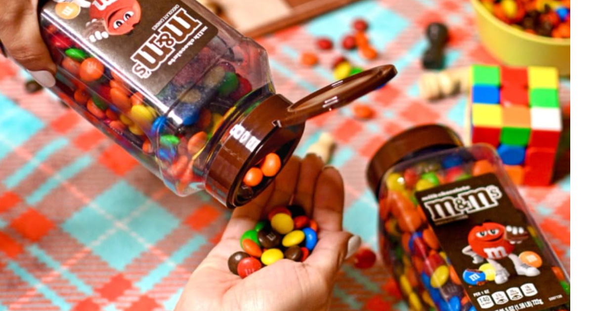 Person pouring a jar of M&Ms into their hand