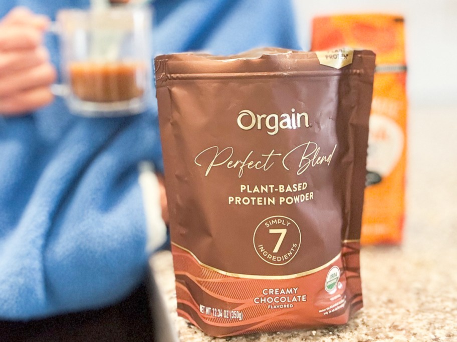 brown bag of Orgain Organic Vegan Perfect Blend Chocolate Protein Powder on counter