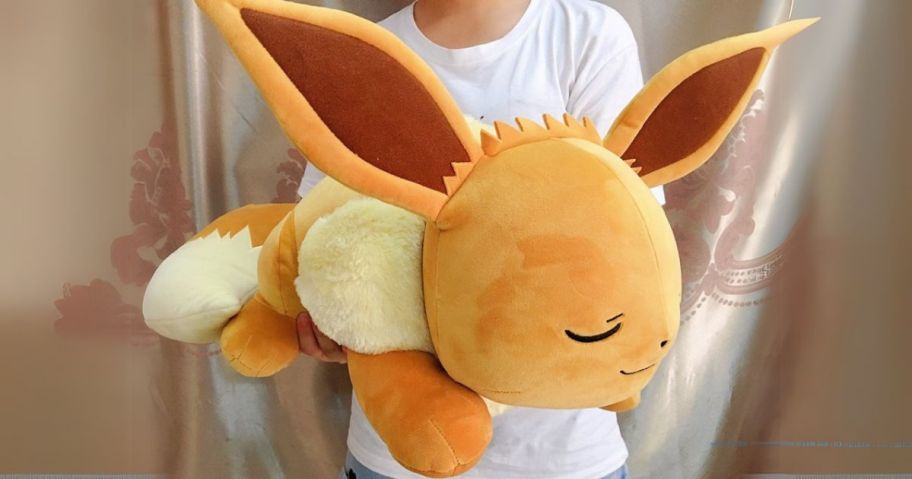 Pokemon Eevee Sleeping Plush in hands