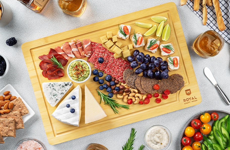 various meats and cheeses displayed on a wood cutting board