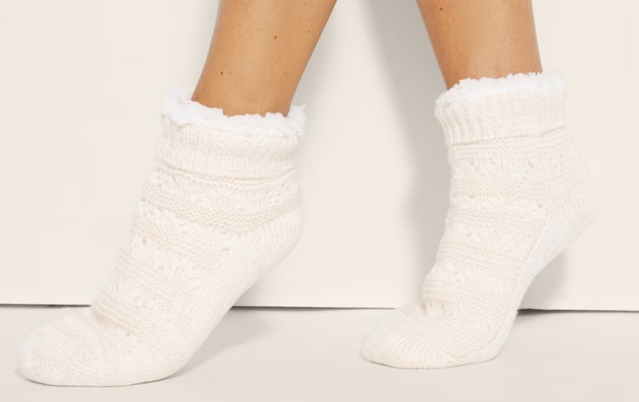 woman wearing a pair of white knit slipper socks