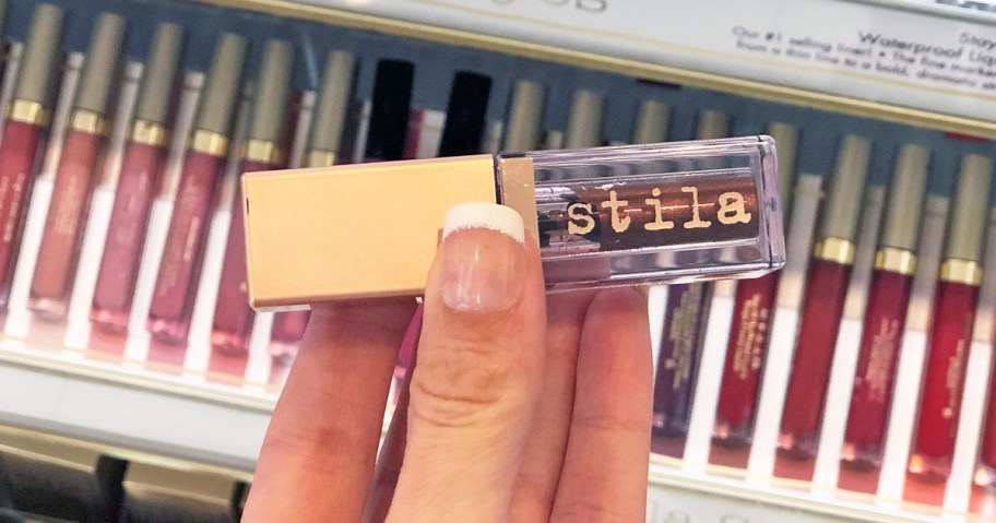 hand holding a Stila liquid eyeshadow in store