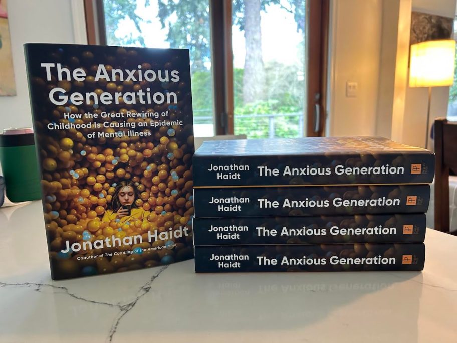 stack of the anxious generation books on kitchen counter