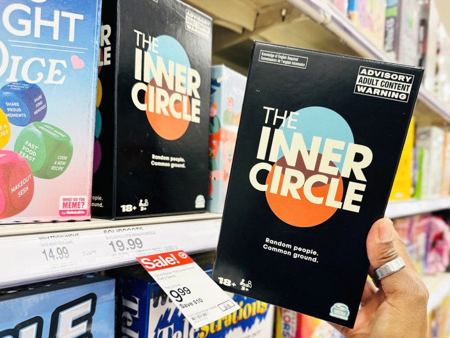 hand holding The Inner Circle Party Game next to store shelf