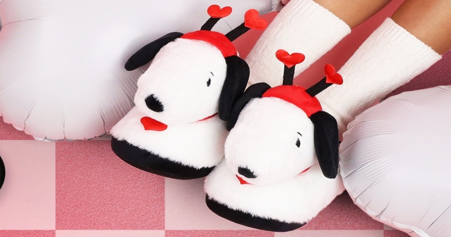 woman wearing a pair of valentine's themed Snoopy slippers