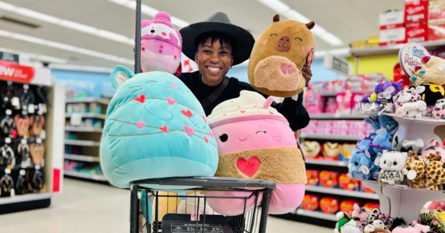 A woman with Squishmallow plush toys in a cart