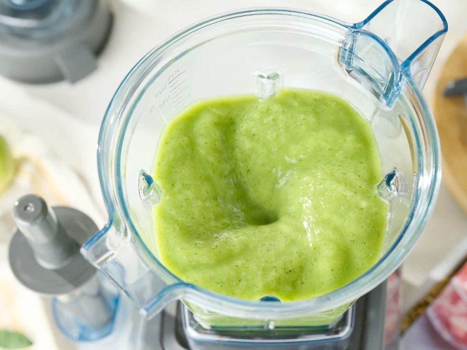 Top down view of a Vitamix blending a green smoothie
