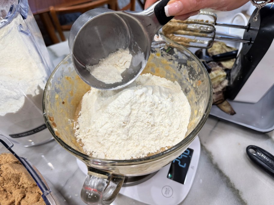 adding flour to banana bread