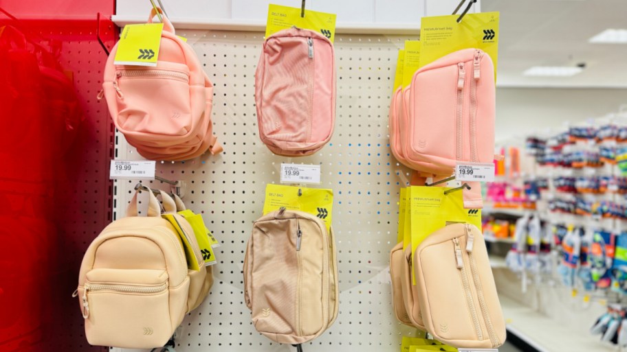 all in motion belt bags and backpacks hanging on a target wall display