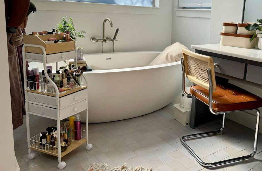 bathroom with makeup stand and retro chair in front of bathtub