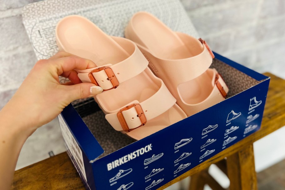 grabbing sandal out of box